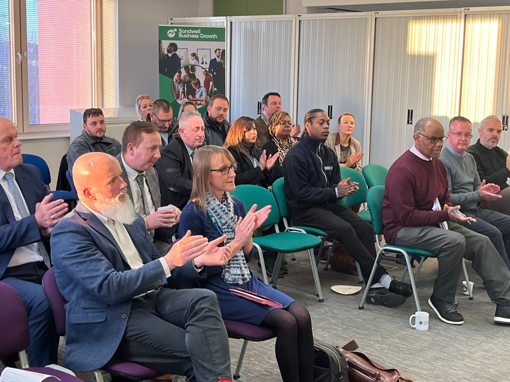 People sitting in green chairs at the Sandwell Start-Up Hub, clapping