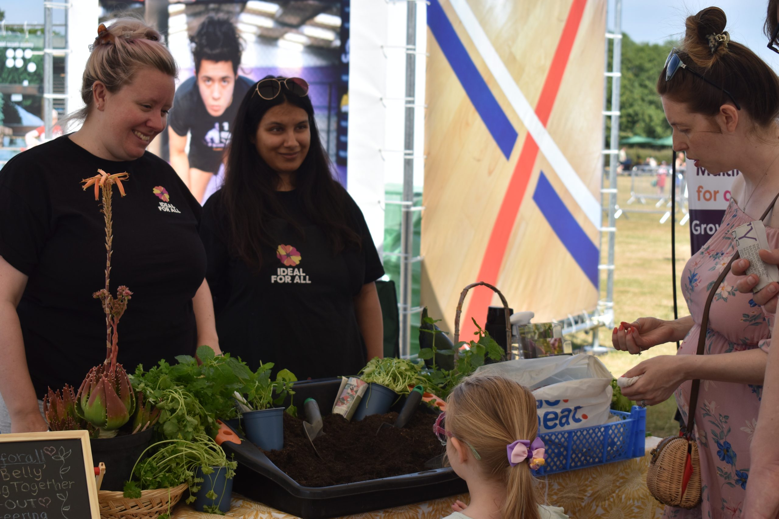 Festival goers at a previous SHAPE Youth Summer Fest, visiting a stall of plants
